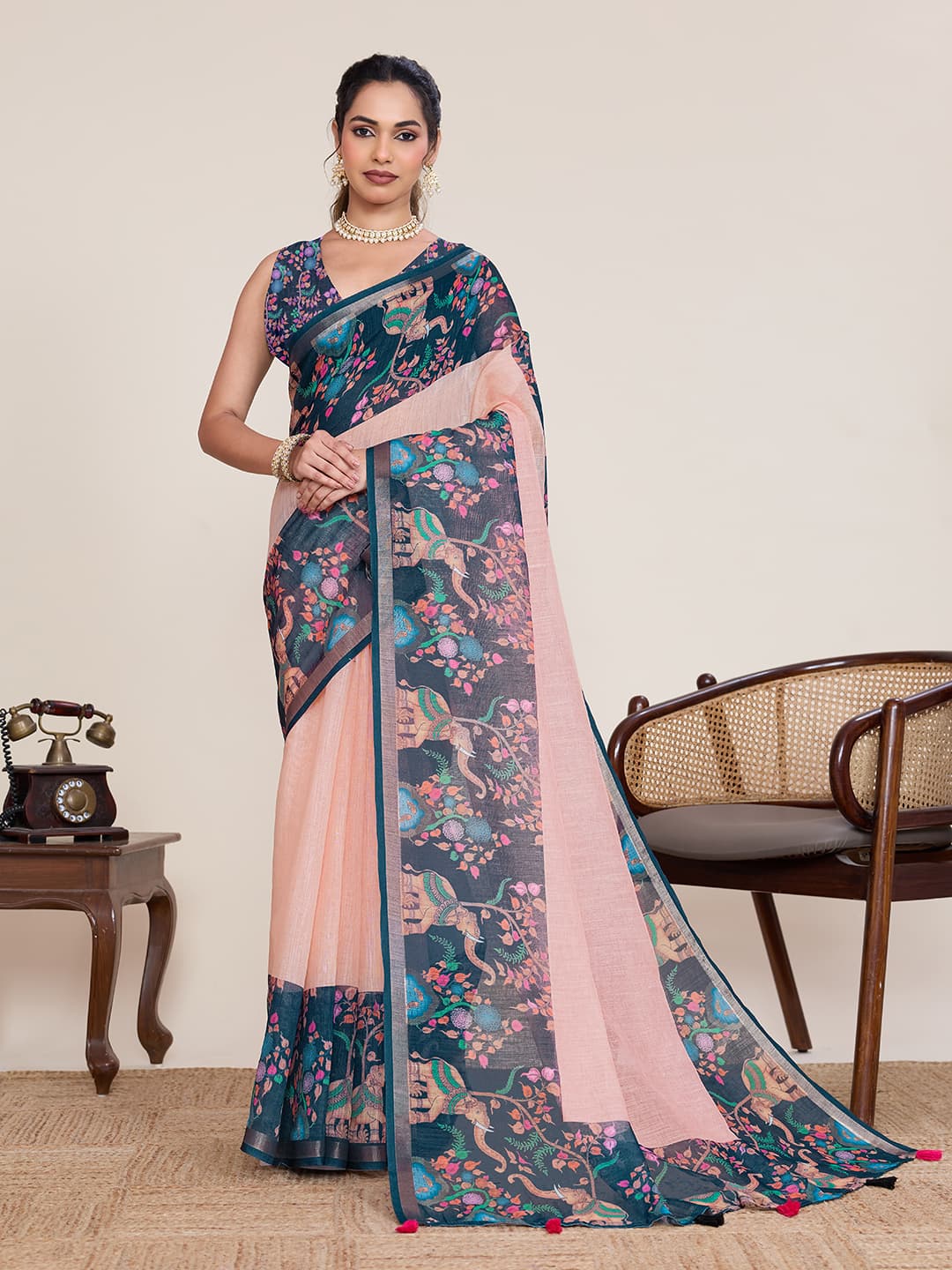 Printed linen saree in teal and pastel peach with a narrow zari border
